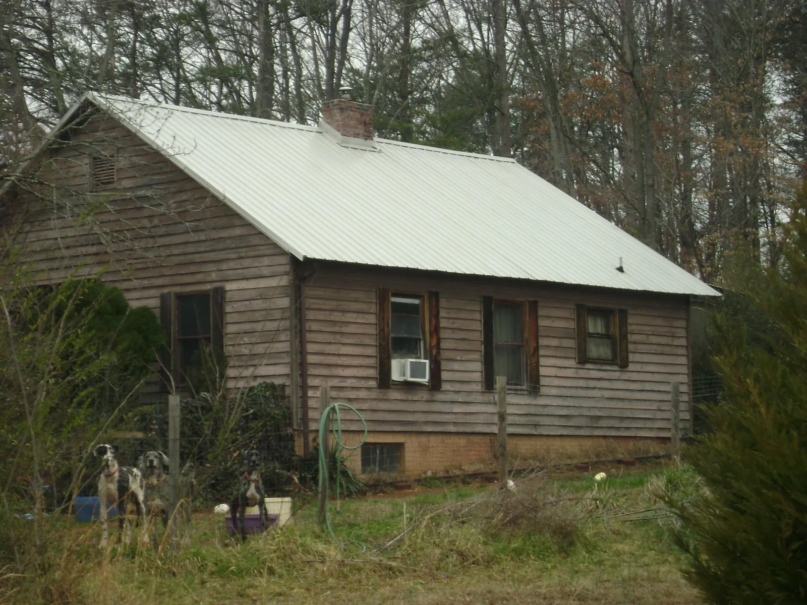 White metal roof on an old wood sided farmhouse, from a Metal Roof Installation job in Londonderry